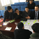 Ian Collins explains the business model canvas to a huddle of North Korean seminar participants.